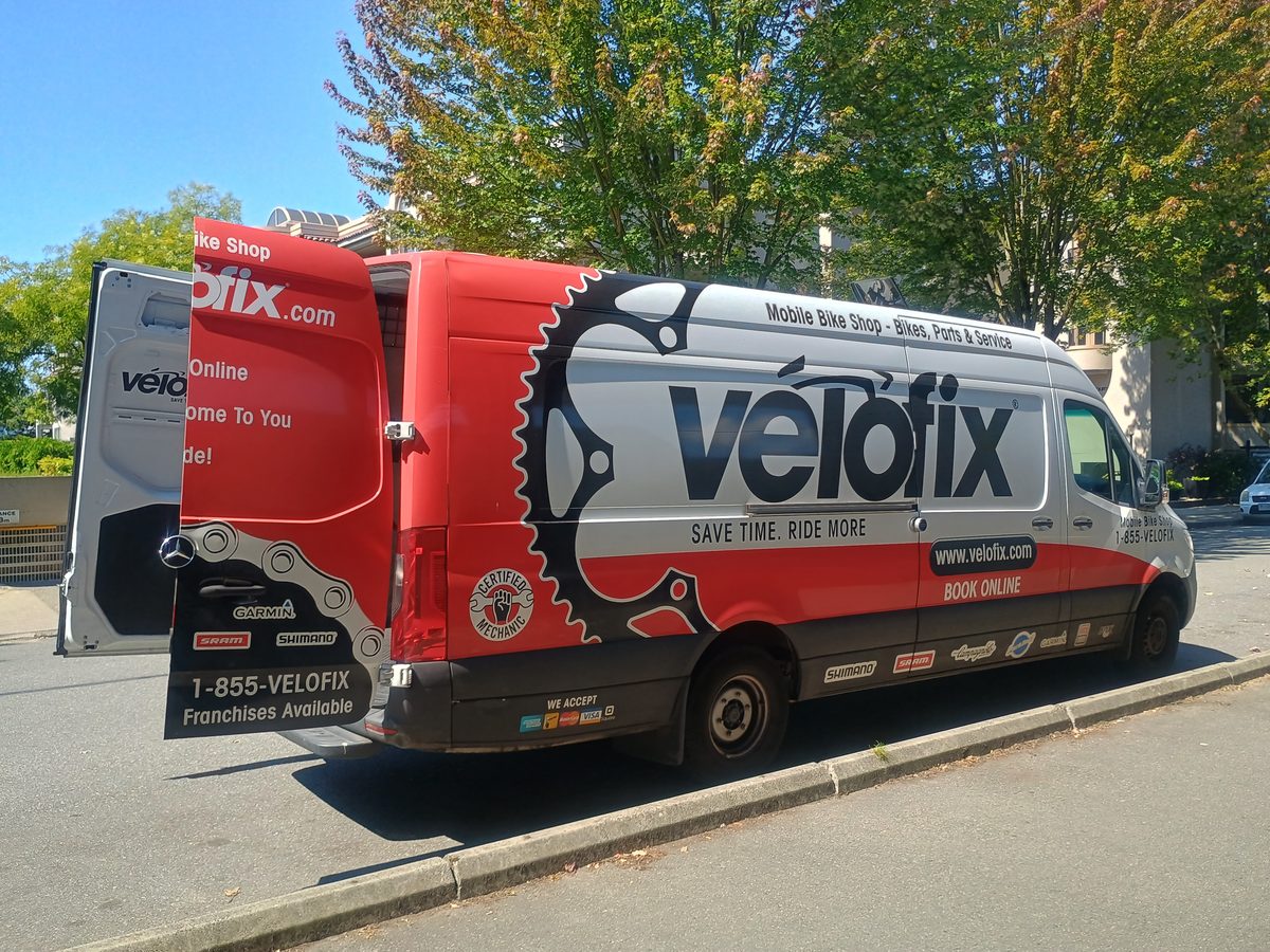 Velofix van with rear doors open showing the workshop inside